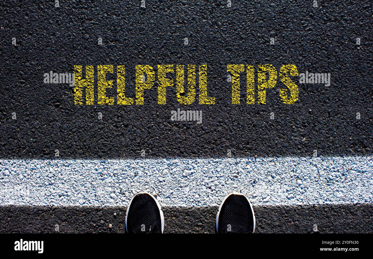 Helpful tips message written on asphalt road. Conceptual helpful tips symbol. Copy space. Stock Photo
