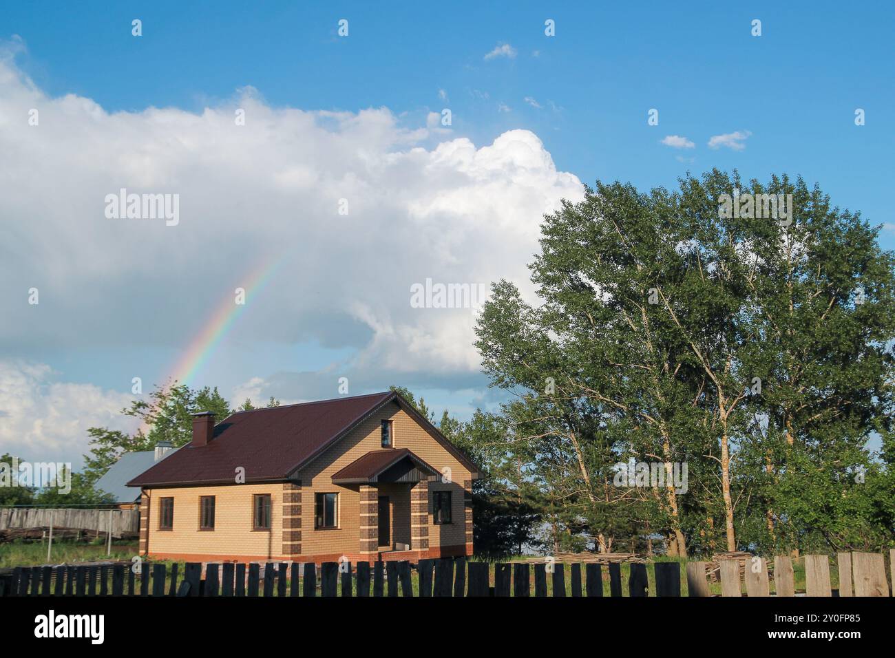 Rainbow over brick house at countryside - rural landscape Stock Photo ...