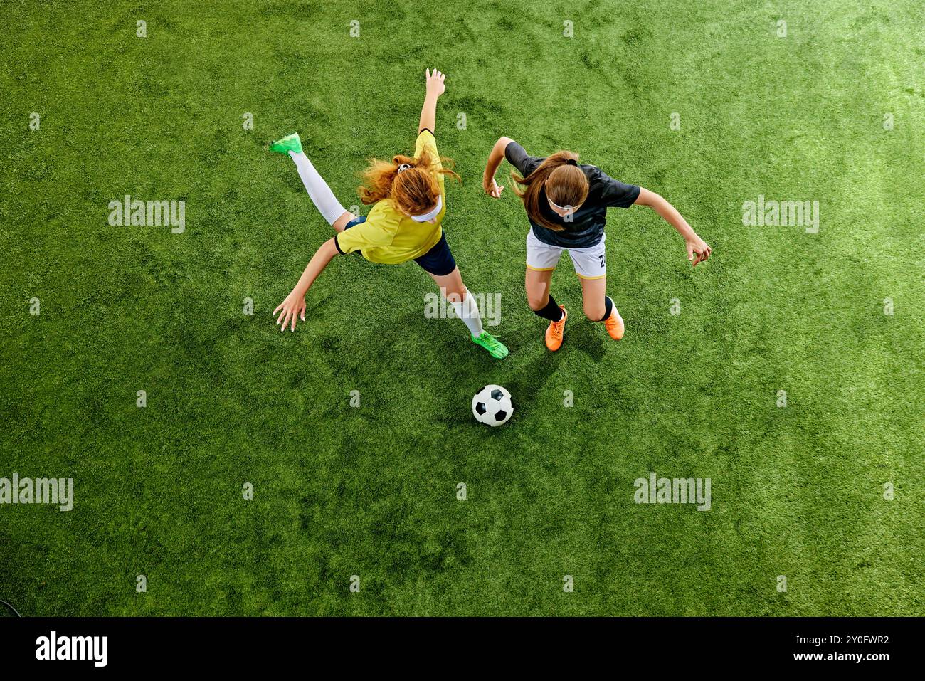 Chasing Fields Dynamic soccer players, two young women chasing ball on vibrant green ...