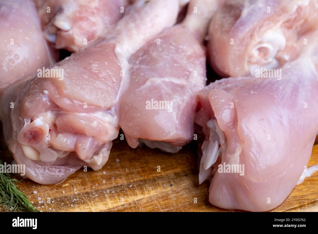 Freshly washed and skinned chicken meat, chicken legs lying on a board and ready for cooking Stock Photo