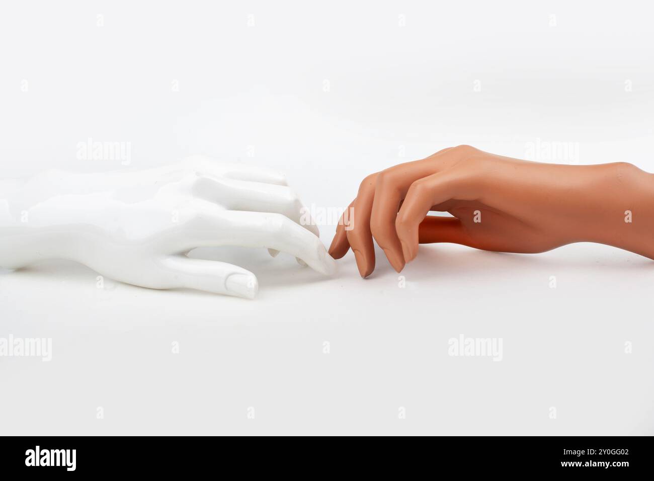 Two Mannequin Hands Reaching Out to Each Other Stock Photo