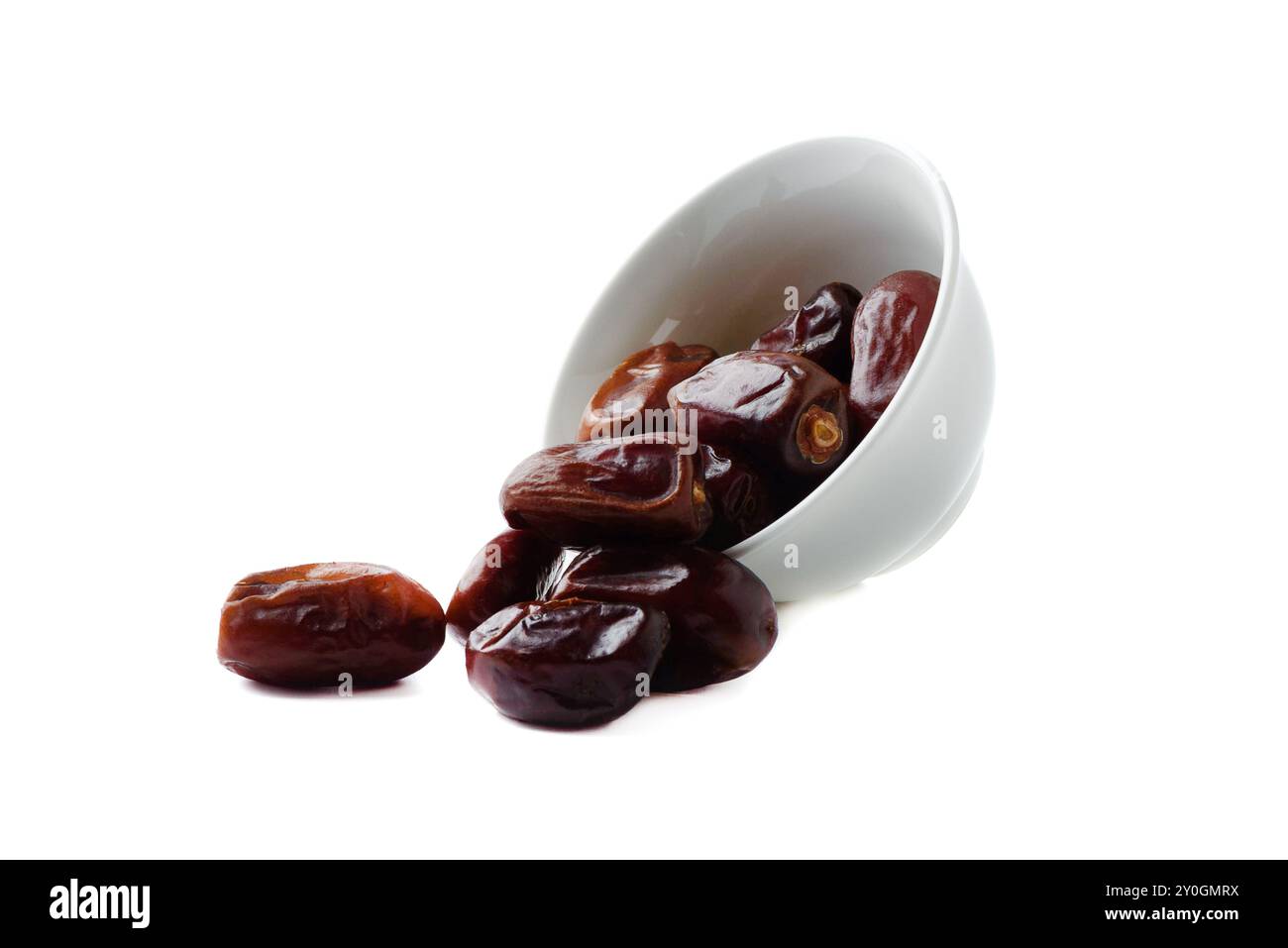 Dried dates from white bowl on white background. Copy space. Stock Photo