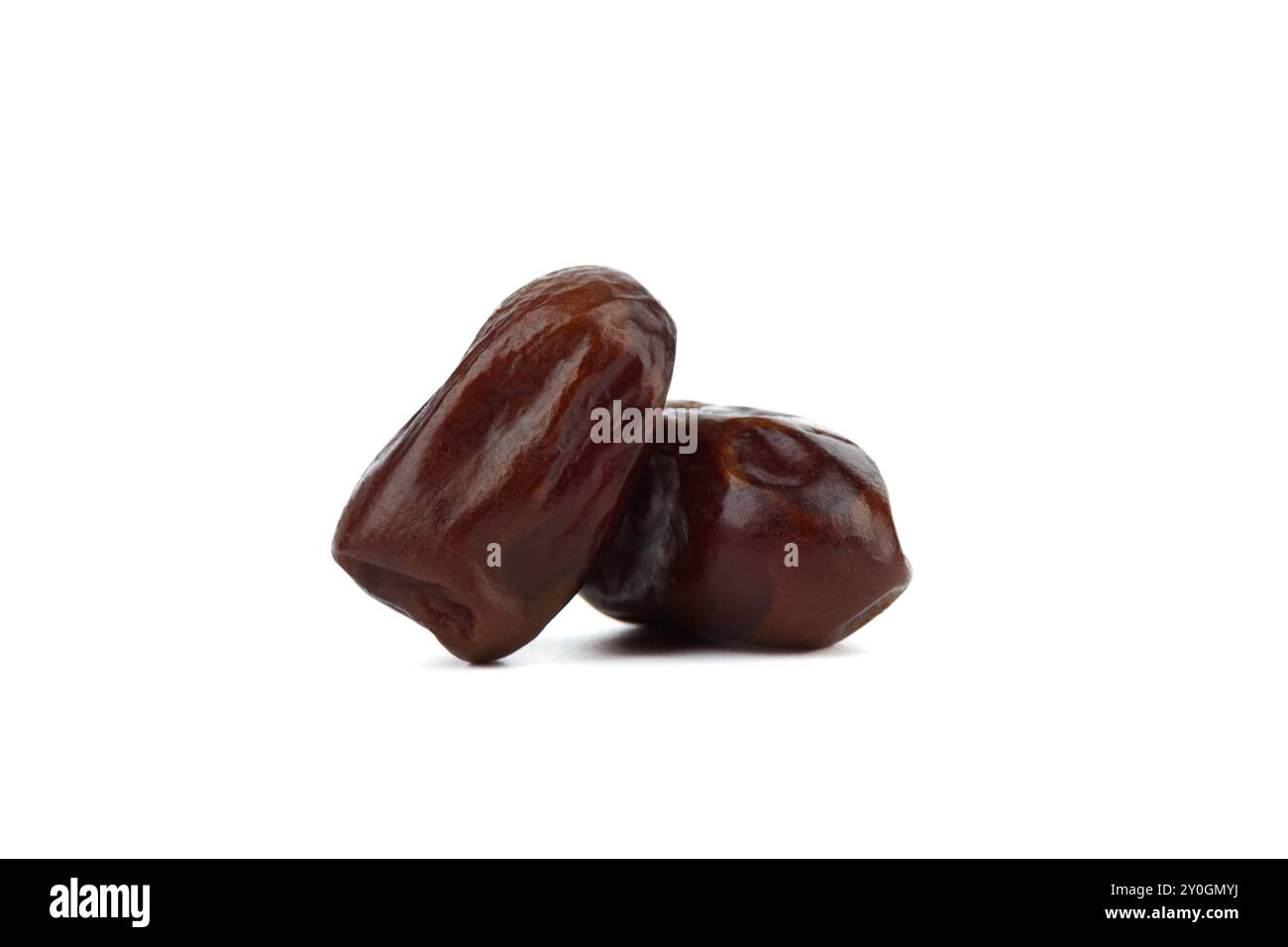 Two dried tropical dates isolated on white background. Copy space. Stock Photo