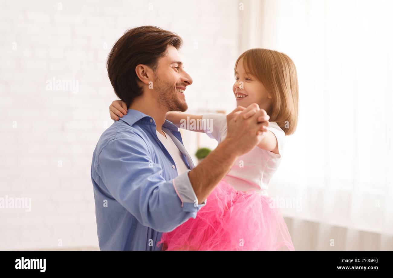 Happy father and daughter dancing together at home Stock Photo - Alamy