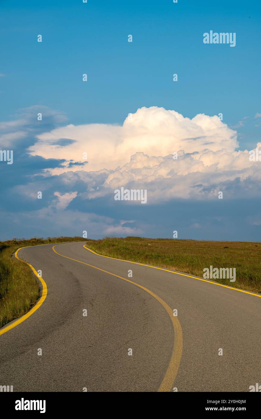 Road leading to beautiful clouds and blue skies. Stock Photo