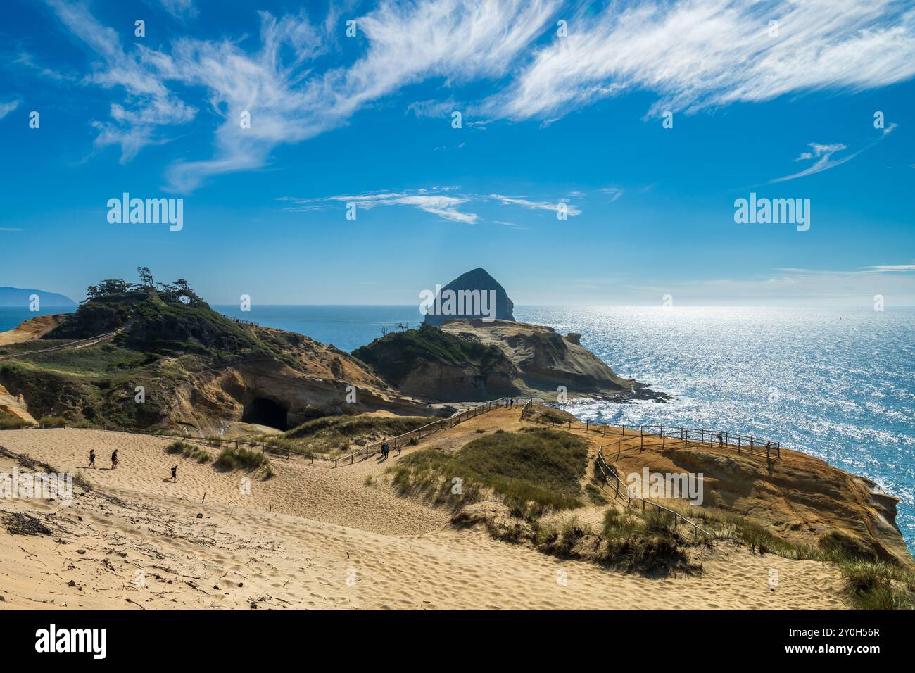 Pacific Coast visitors hike at Cape Kiwanda State Natural Area dune and sandstone formations at Pacific City, Oregon, USA Stock Photo