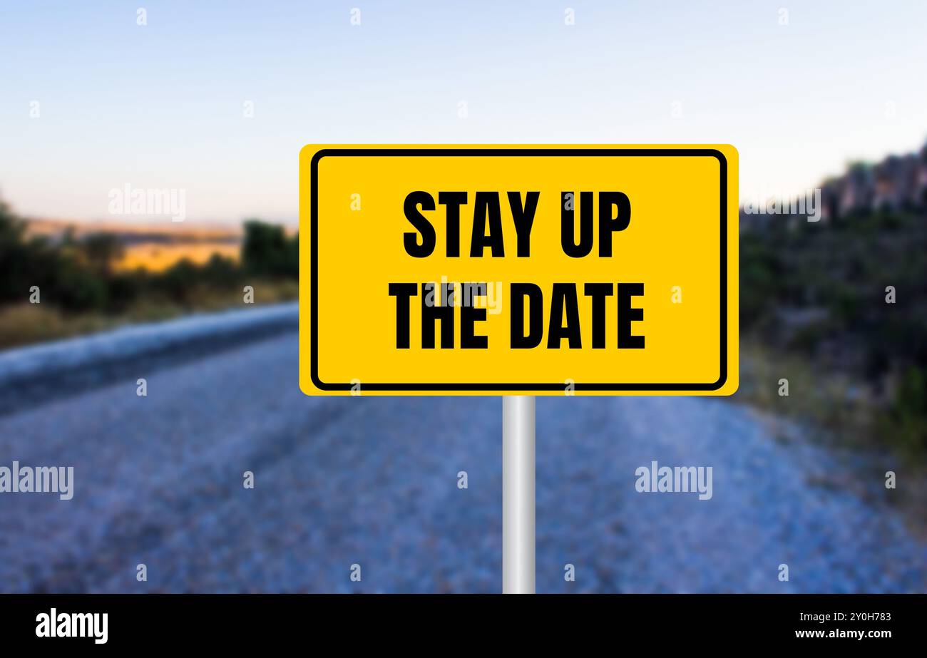 Stay up the date message written on yellow road sign. Conceptual stay up the date symbol. Copy space. Stock Photo