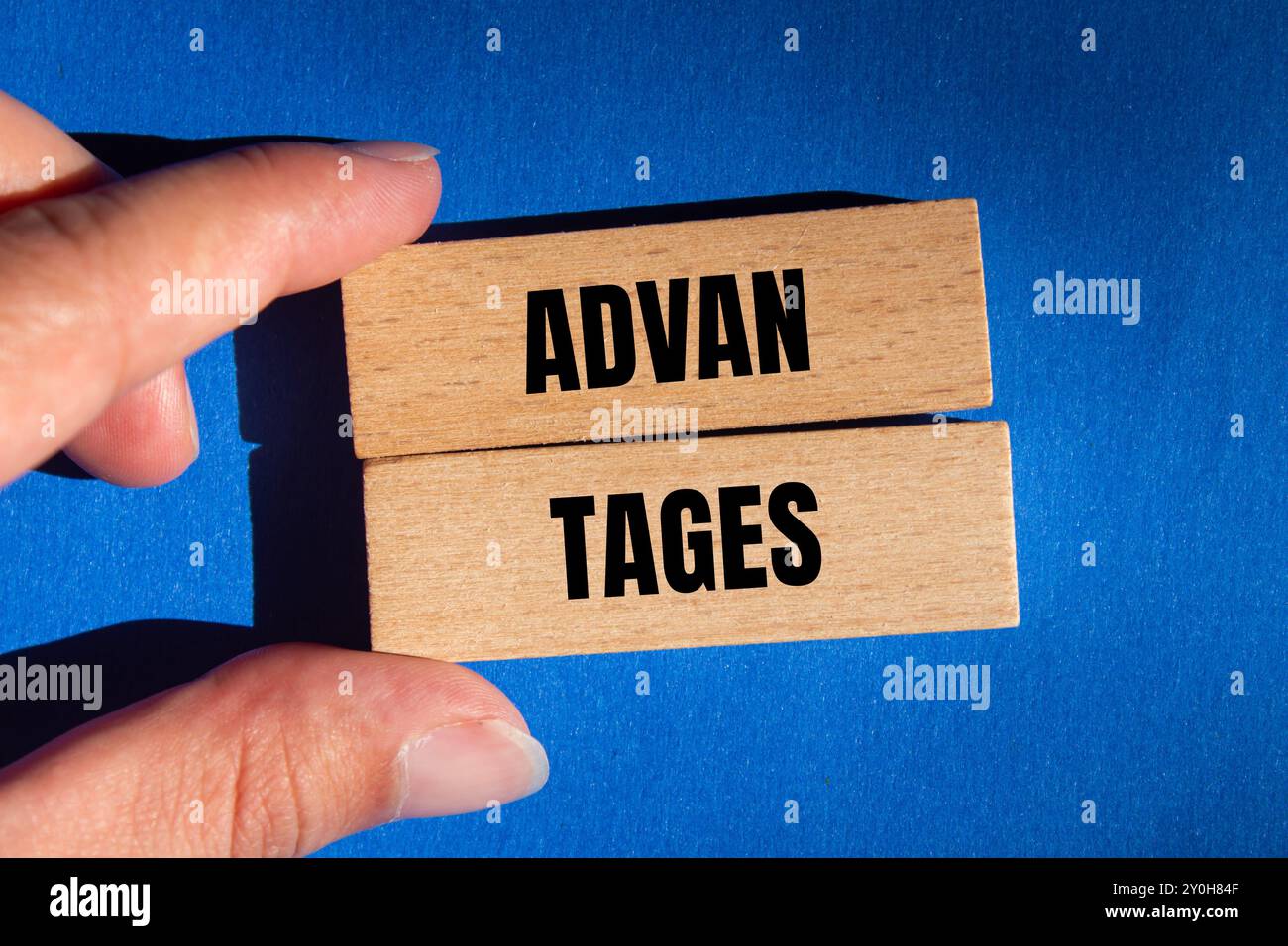 Advantages message written on wooden blocks with blue background. Conceptual advantages symbol. Copy space. Stock Photo