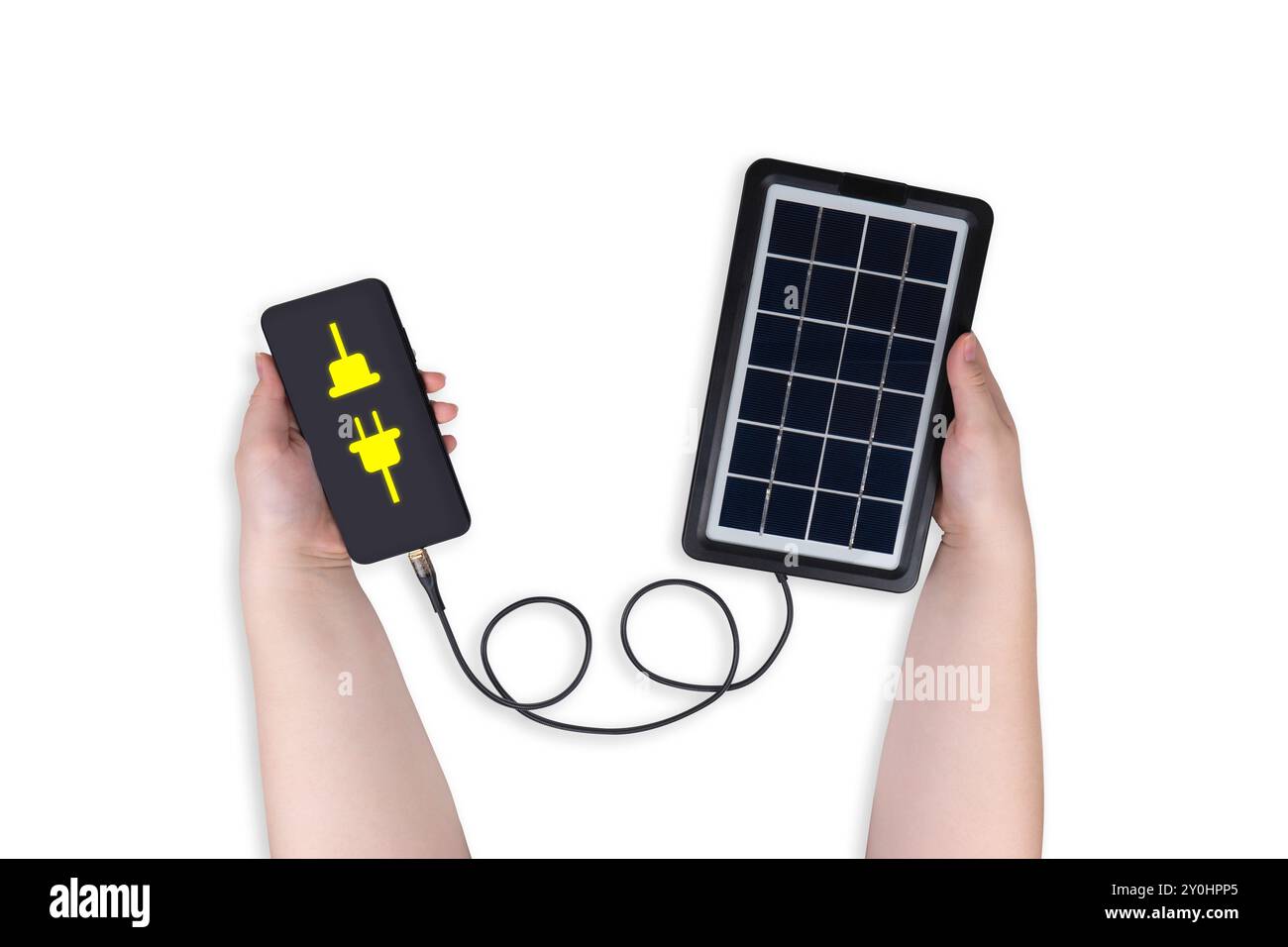 Portable solar panel in hand connected to smartphone in other hand on ...