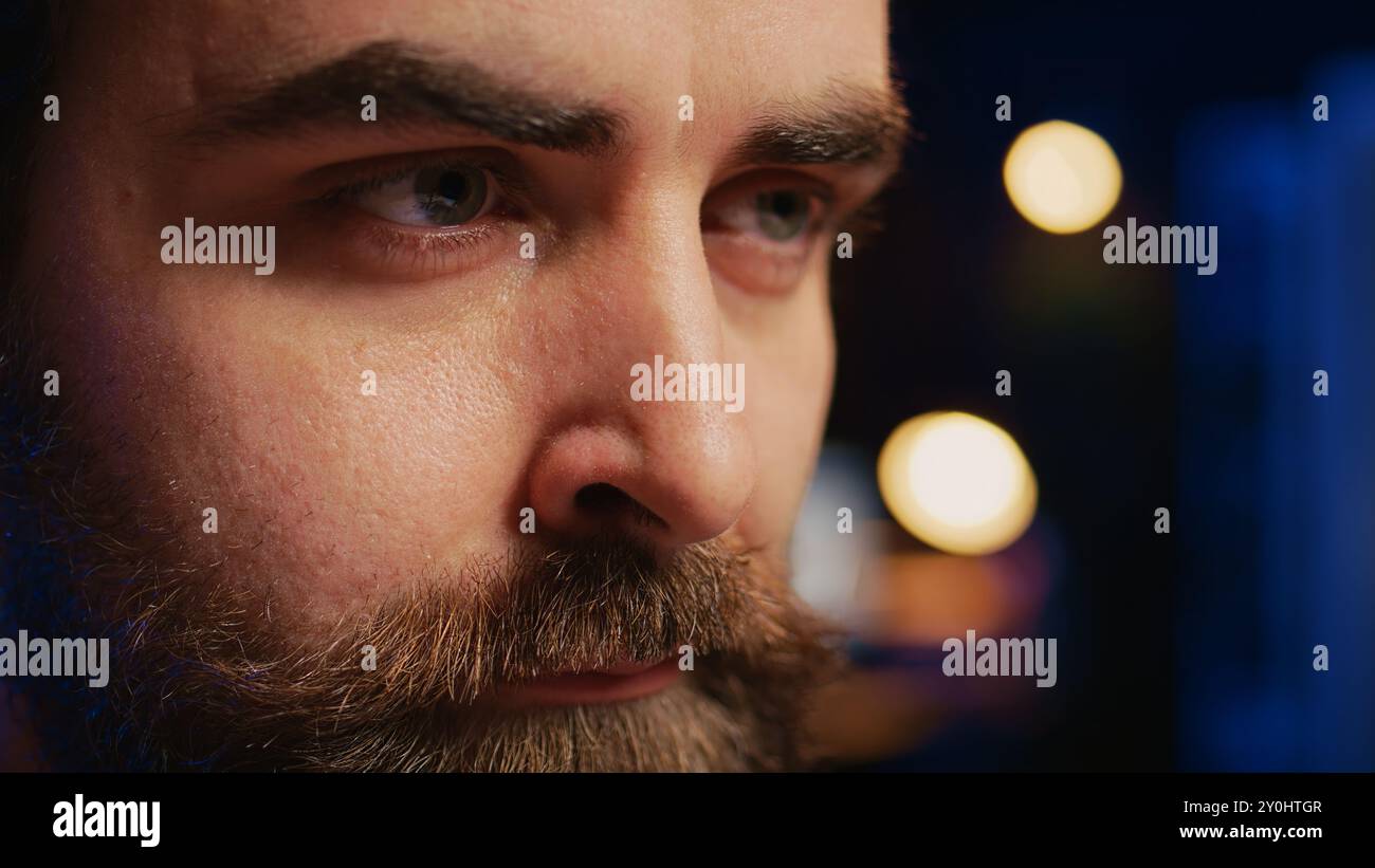 Developer in home office concentrating hard while doing coding on computer, extreme close up shot. Focus on IT admin paying close attention to screen while writing lines of code, camera B Stock Photo