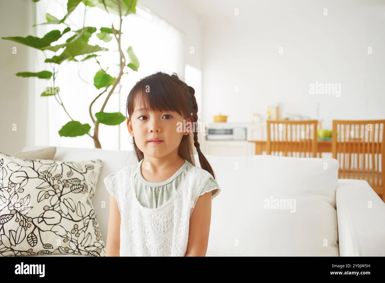 Girl sitting on the sofa hi-res stock photography and images - Alamy