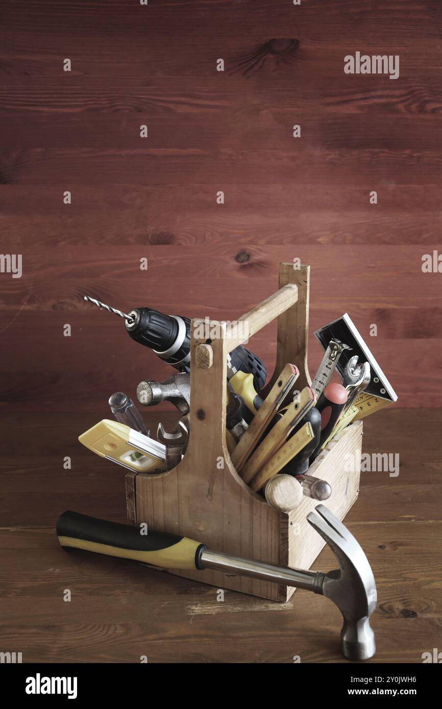 Wooden toolbox with tools on wood background Stock Photo - Alamy