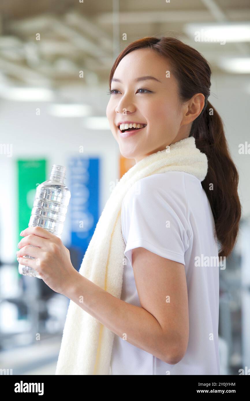 Smiling woman holding a plastic bottle Stock Photo