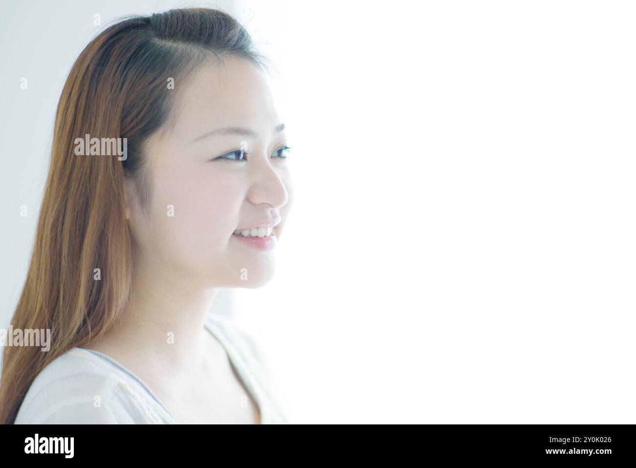 Profile of woman in her 20s smiling Stock Photo - Alamy
