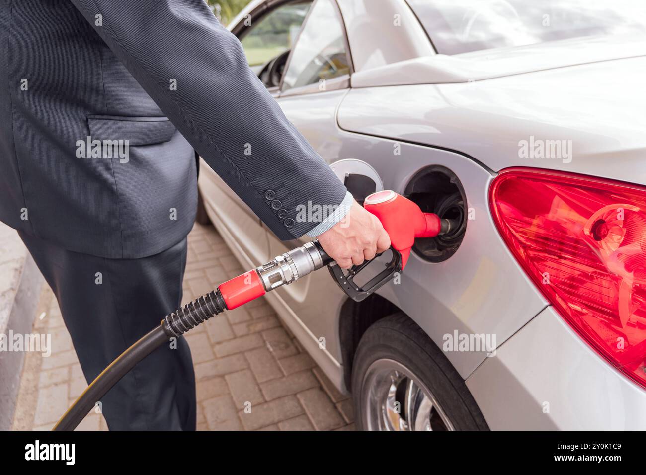 Closeup of woman pumping gasoline fuel in car at gas station. Petrol or ...