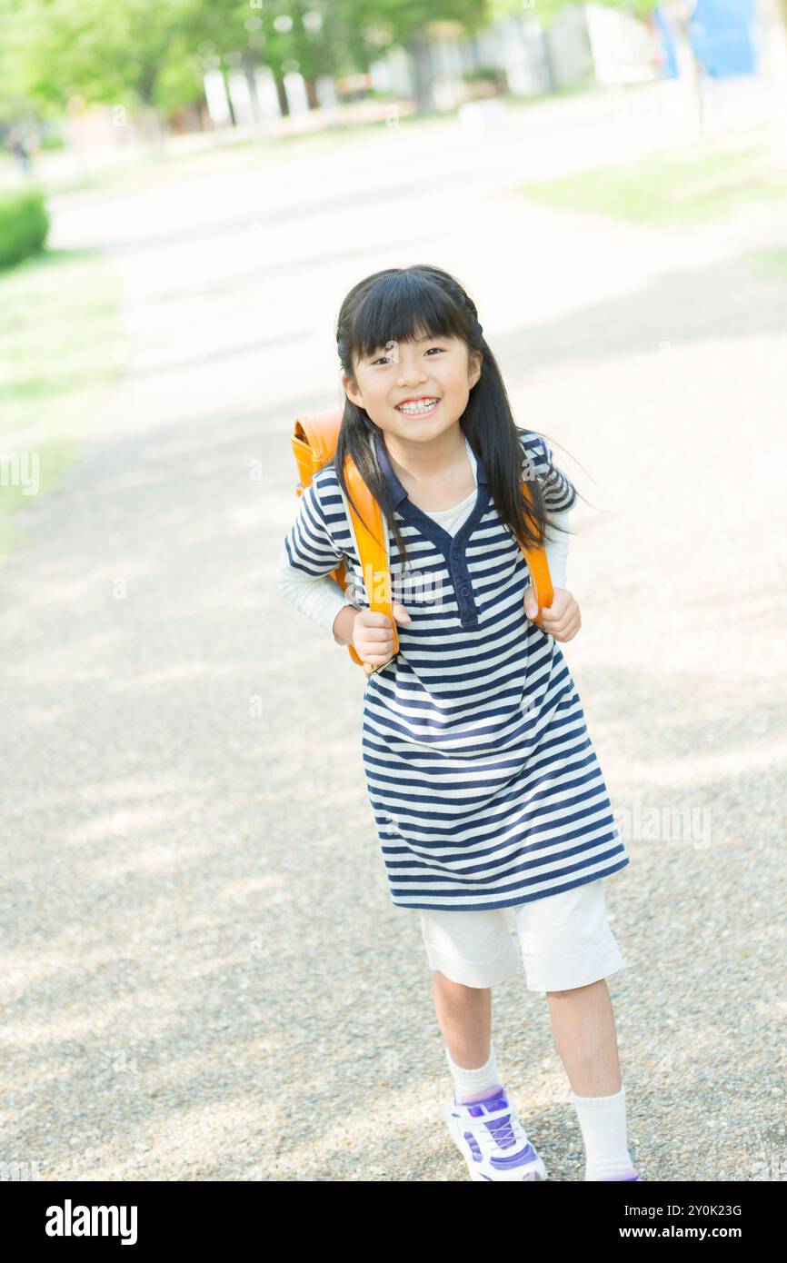 Girl carrying satchel on her back Stock Photo