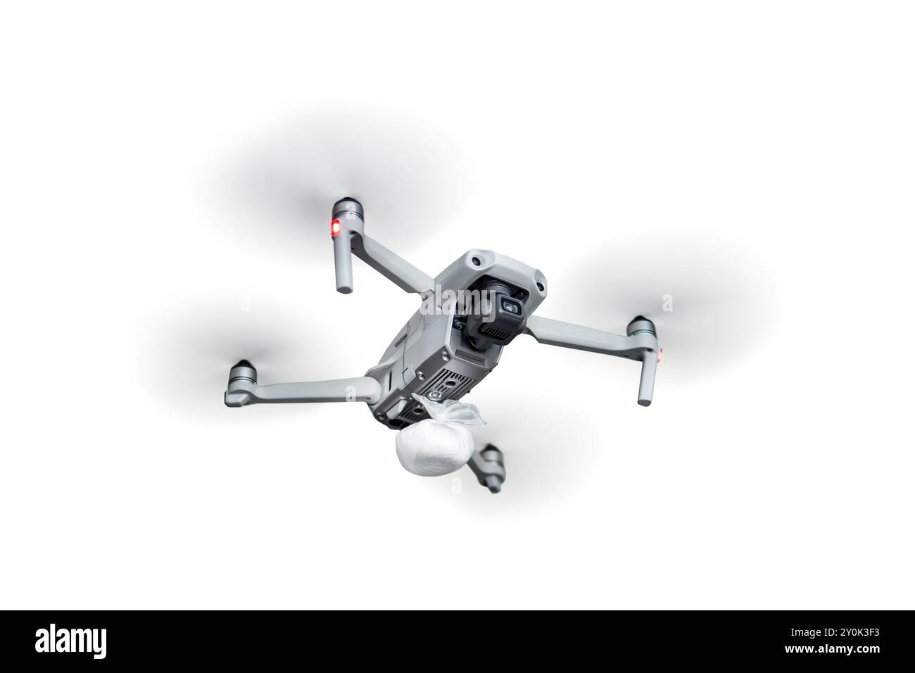 A bag of cocaine on a quadrocopter. Delivery of heroin by air with the help of unmanned aerial vehicles. concept drug distribution. A flying quadcopte Stock Photo
