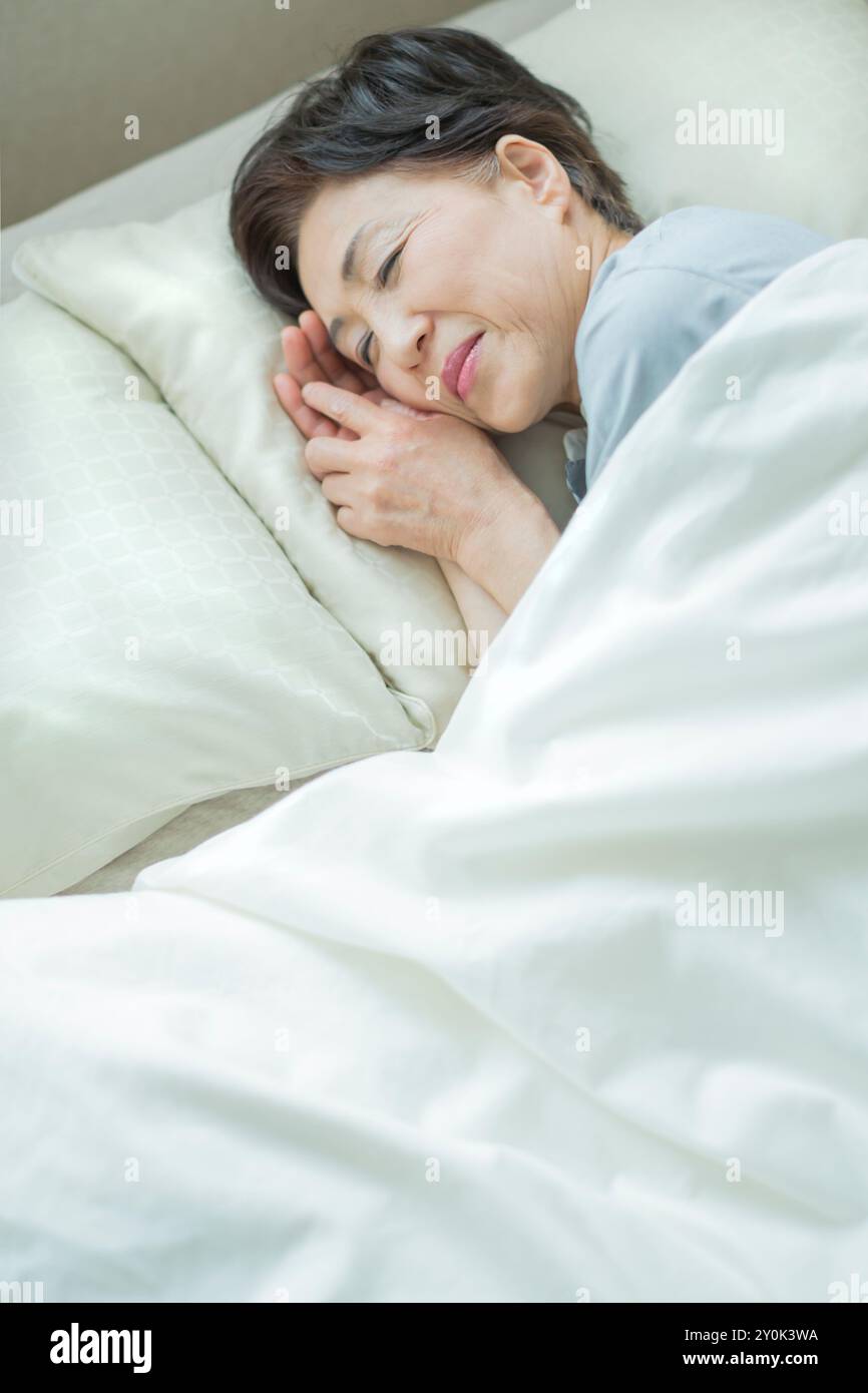 Mature woman sleeping bed hi-res stock photography and images - Alamy