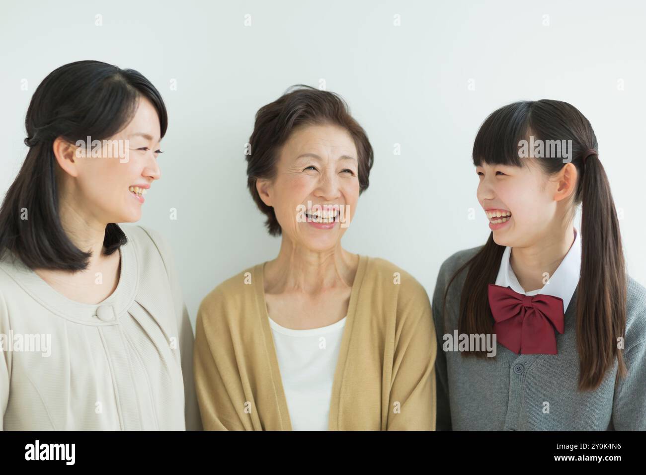 Three generation family smiling Stock Photo - Alamy