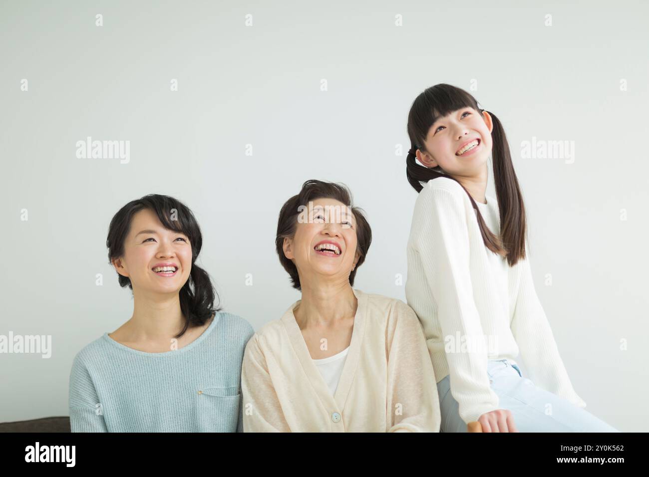 Three generation family smiling Stock Photo - Alamy