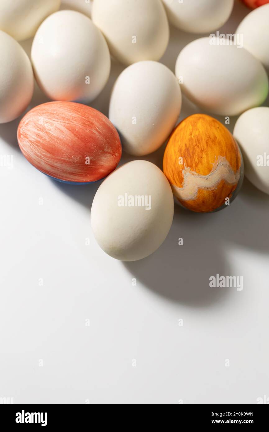 Happy Easter concept. Colorful Easter eggs on a white background with copy space for text. Stock Photo
