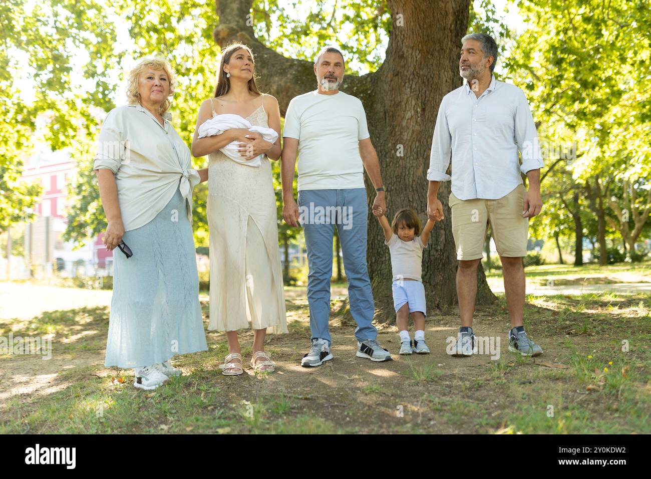 Happy family posing with newborn baby in park Stock Photo - Alamy