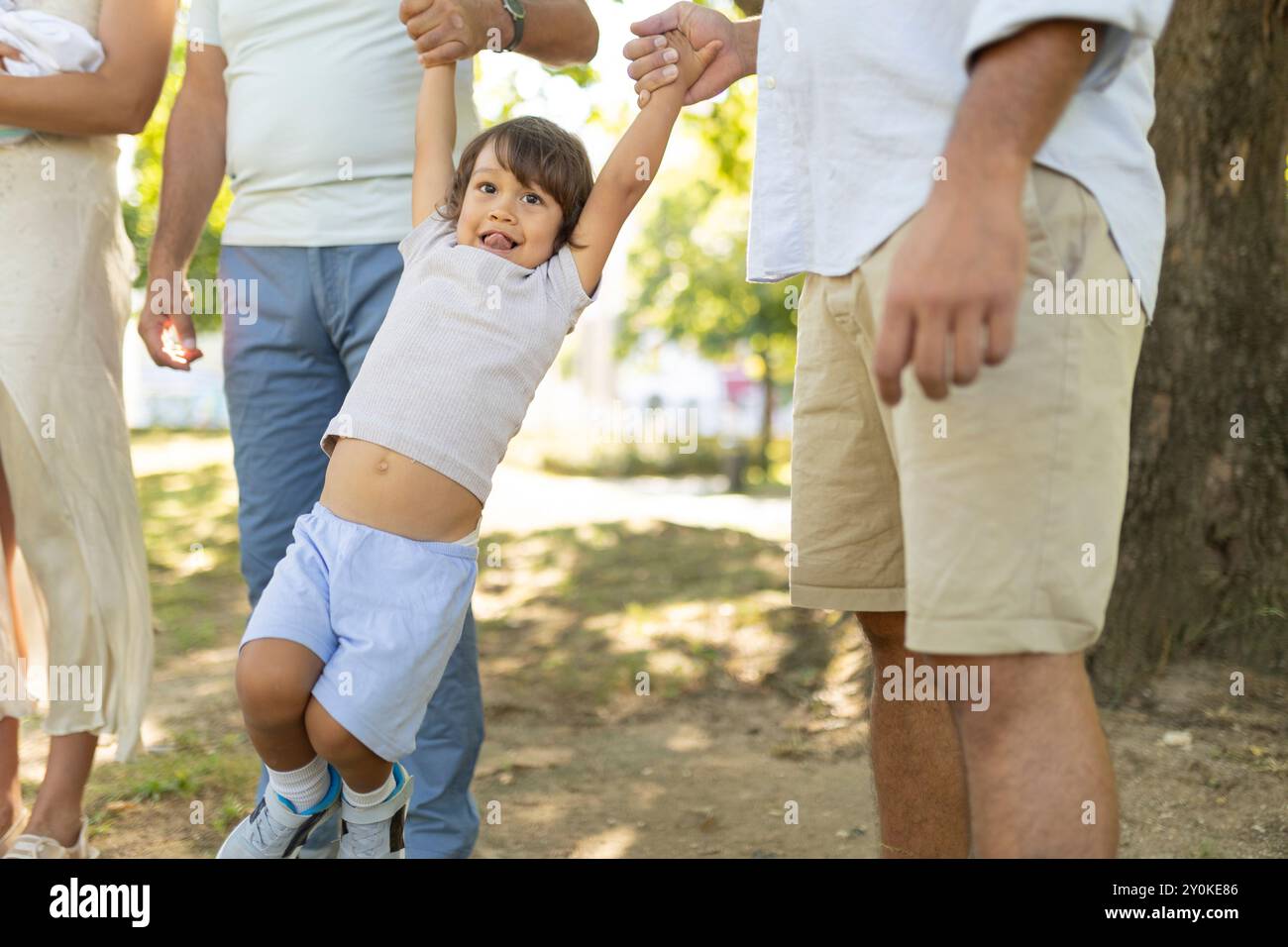Happy family walking together in the park on a sunny day Stock Photo ...