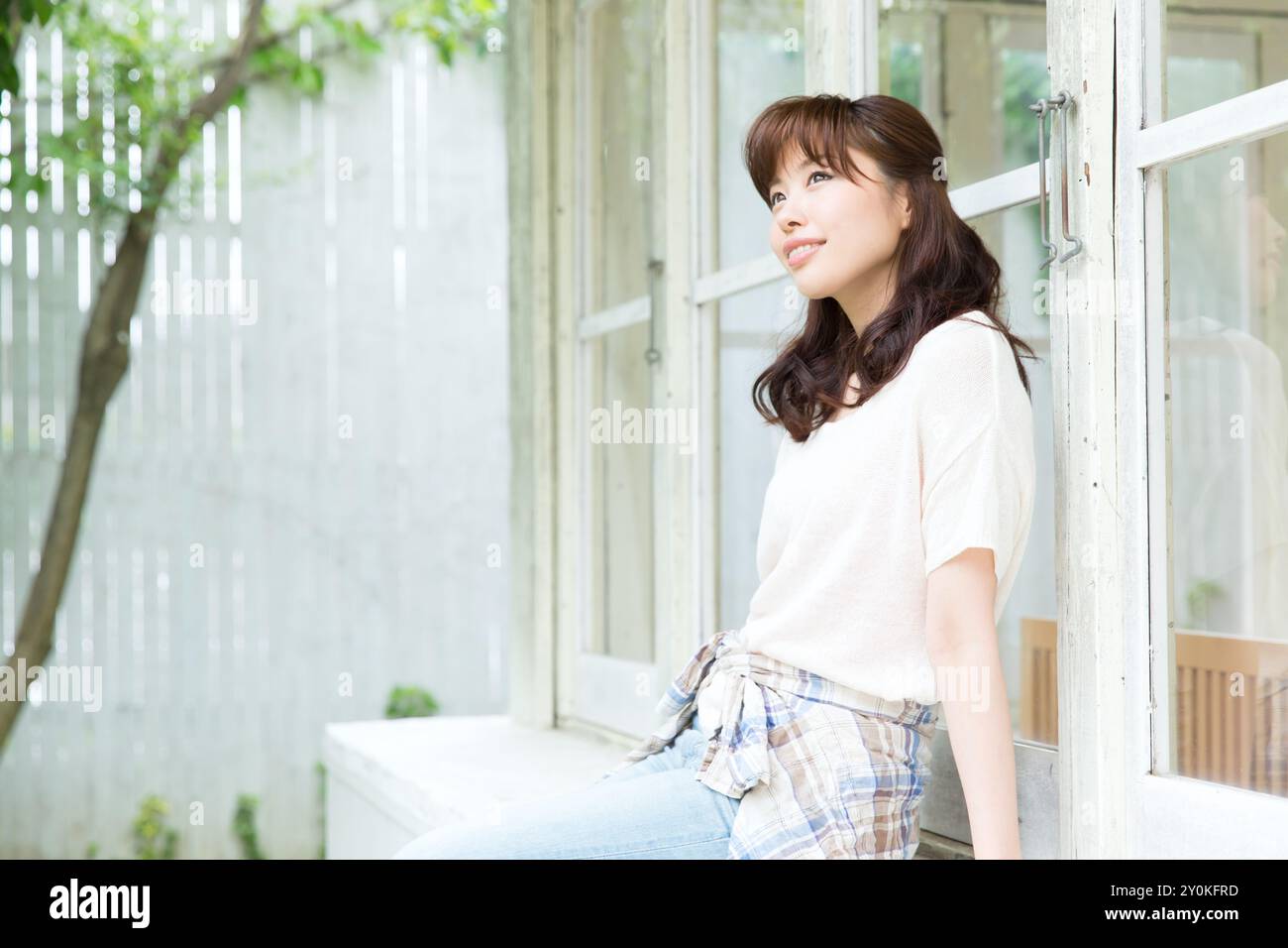 Young woman relaxing in the garden Stock Photo - Alamy