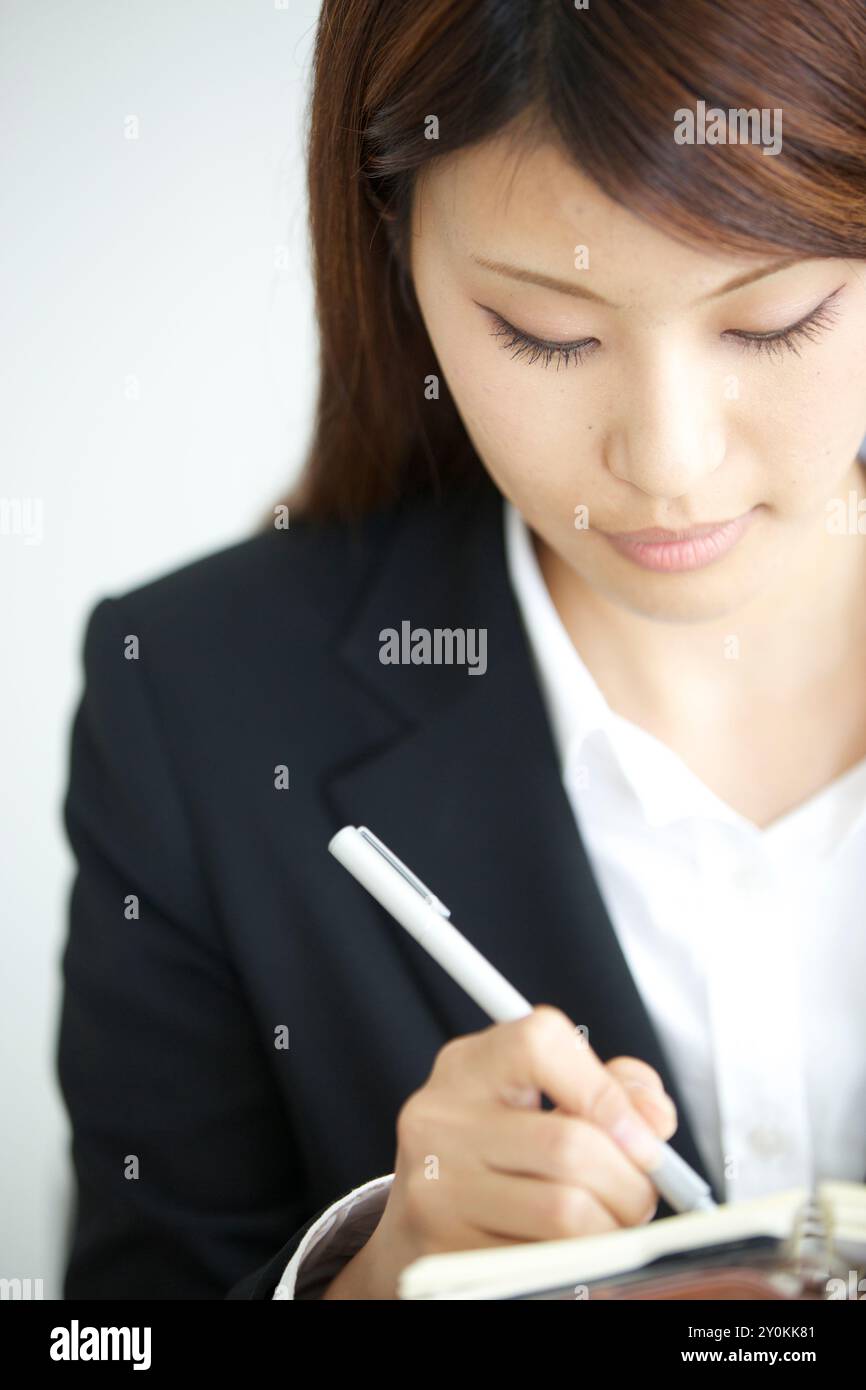 Woman writing pen holding hi-res stock photography and images - Alamy