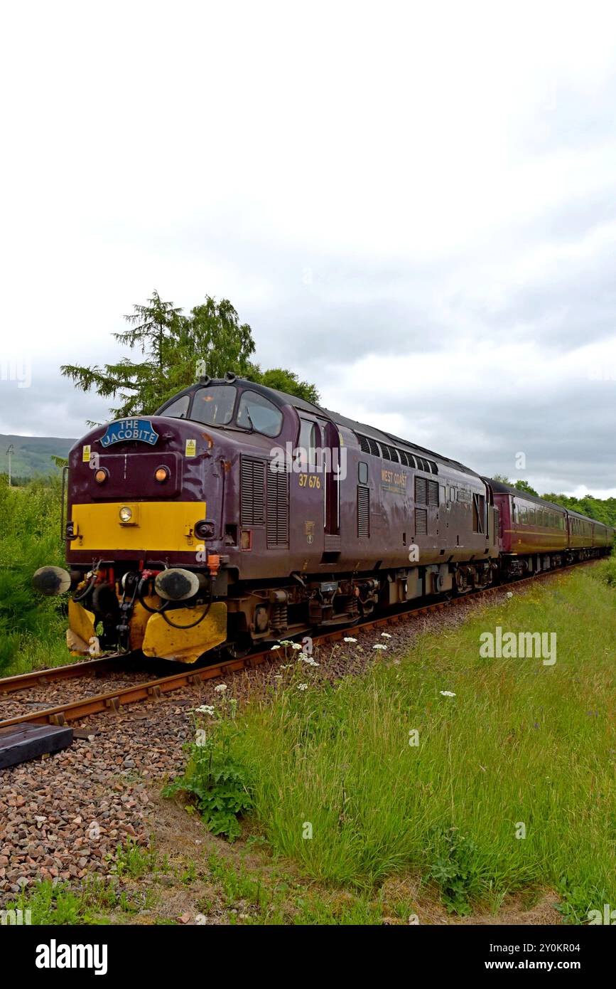 West Coast Rail diesel loco 37676 with The Jacobite heading for  Mallaig, near Locheilside Station, 2nd July 2024 Stock Photo