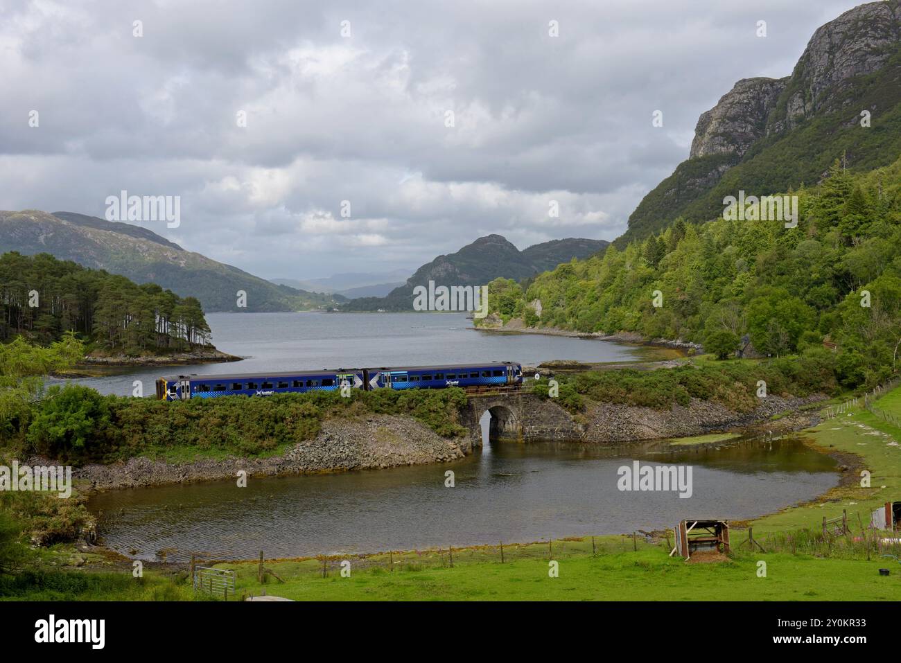Scotrail Inverness to Kyle train service approaching Plockton alongside Loch Carron, Scotland, July 2024 Stock Photo