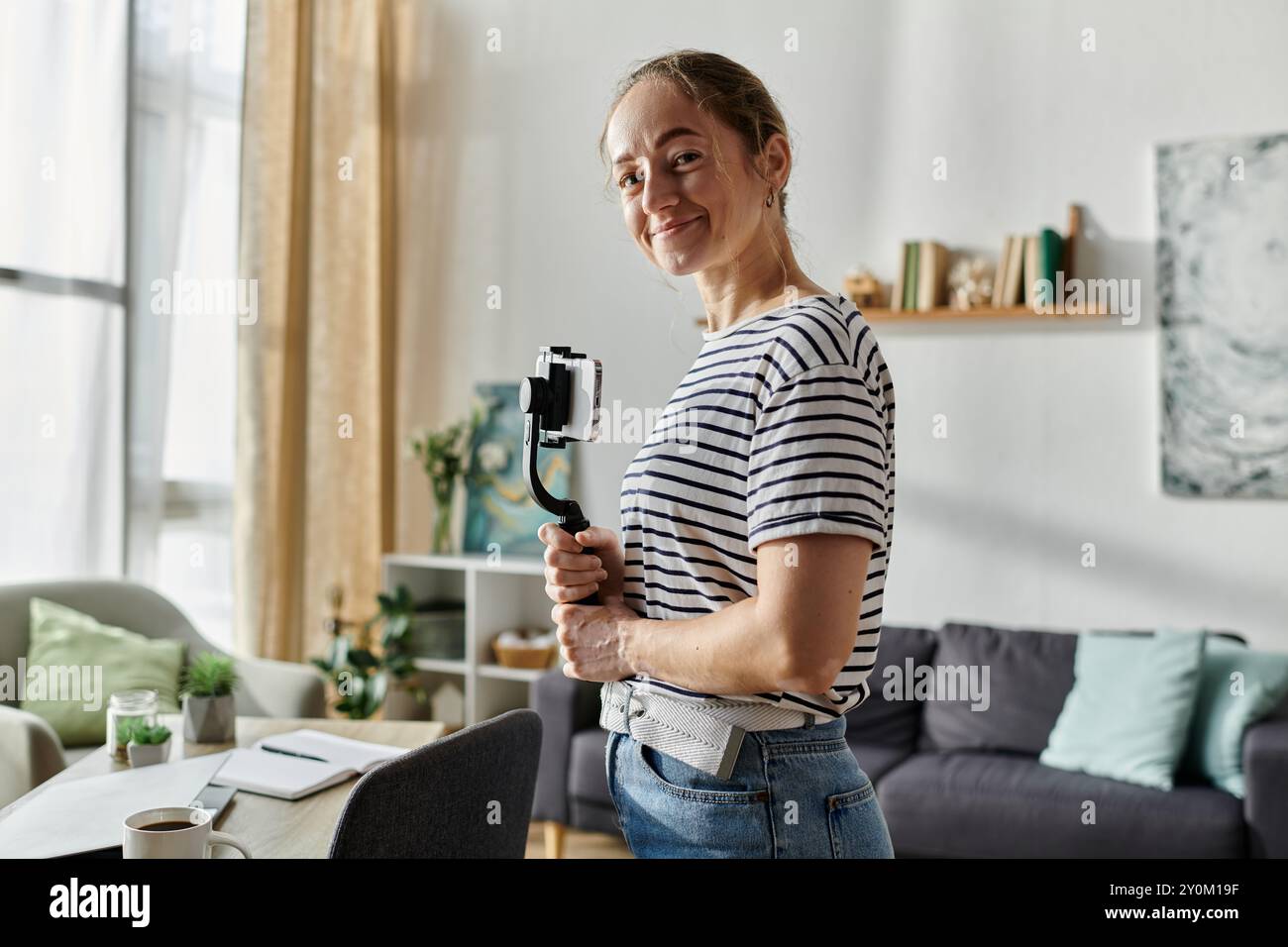 A joyful woman with vitiligo poses confidently with her camera. Stock Photo