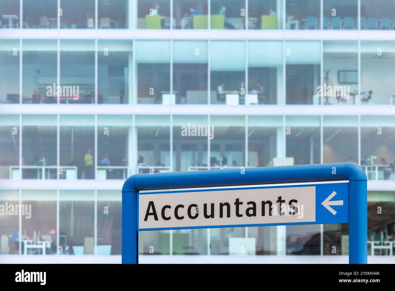 Accountants information sign in front of a blurred office with working people Stock Photo