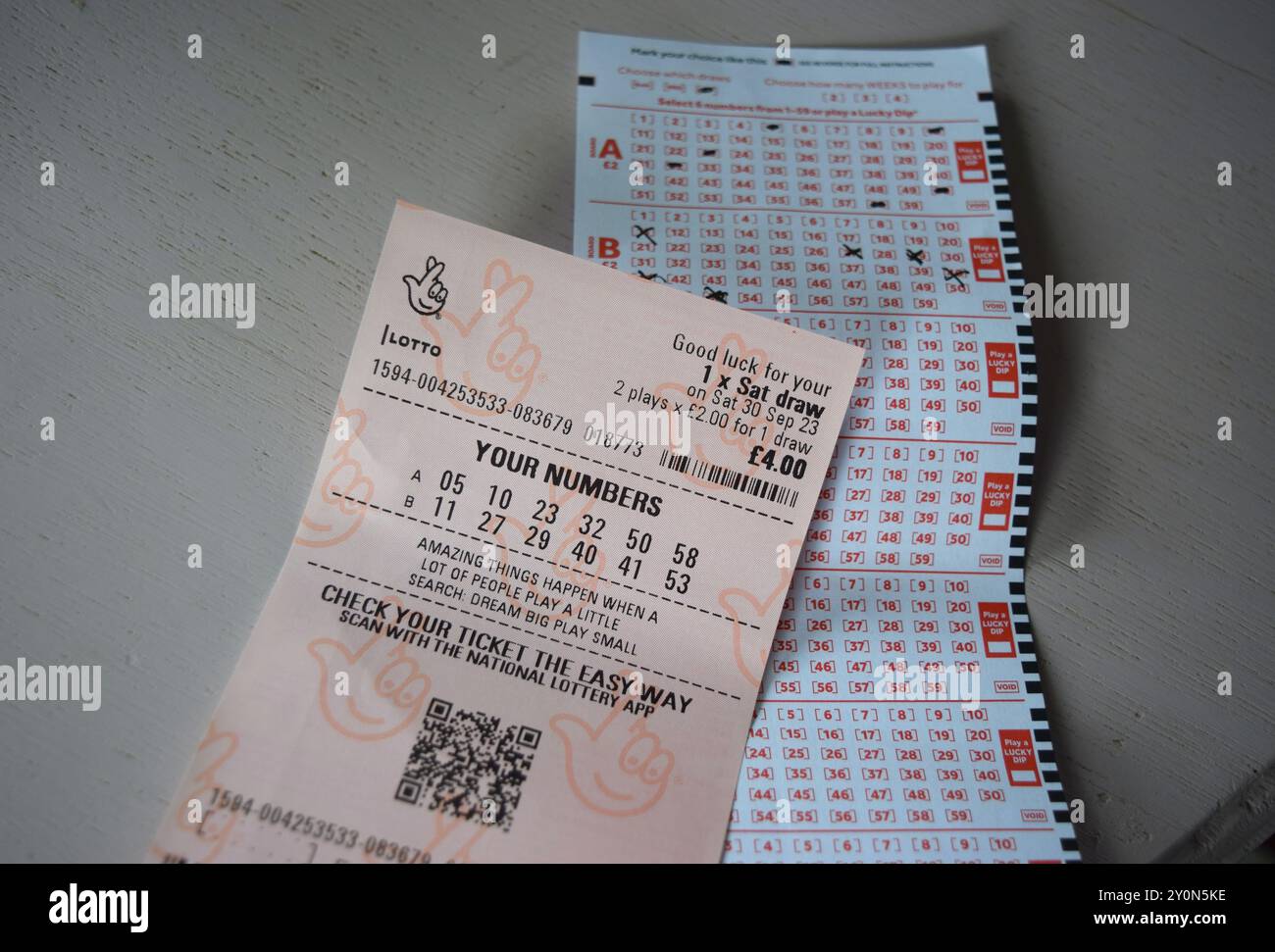 UK lottery Lotto ticket and slip on neutral background. Stock Photo