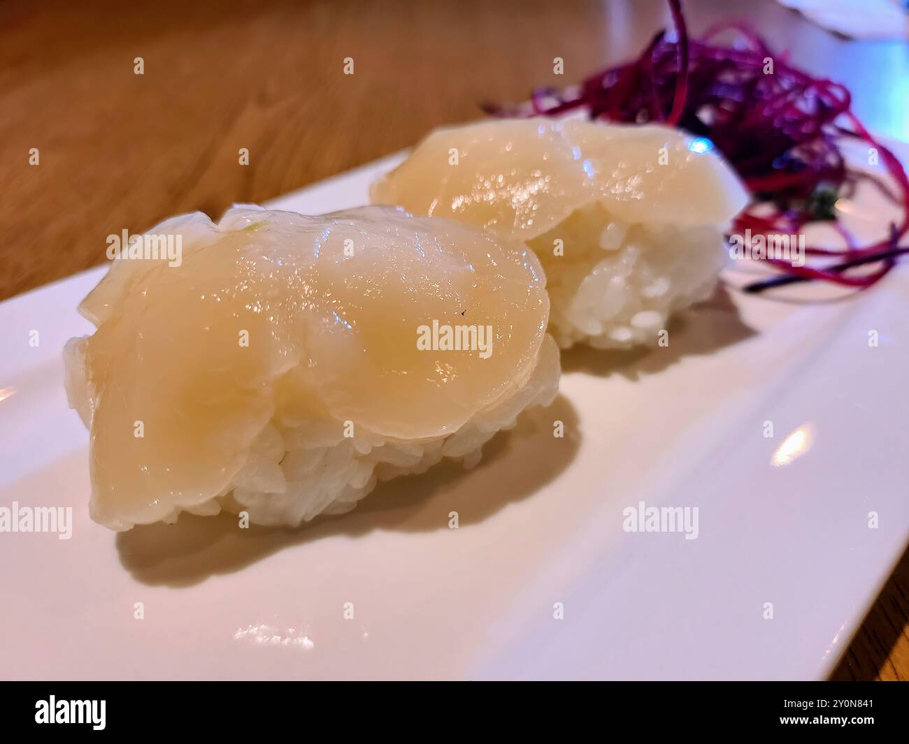 Scallop Sushi on White Plate Eye-Level Close-Up Stock Photo