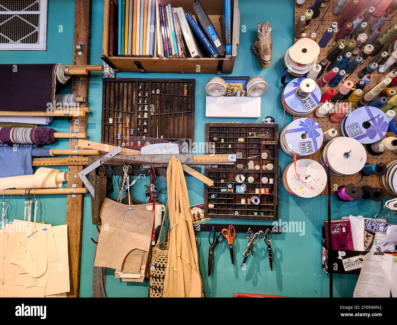 Vibrant Sewing Workshop with Thread Spools and Tools at Eye Level Stock Photo