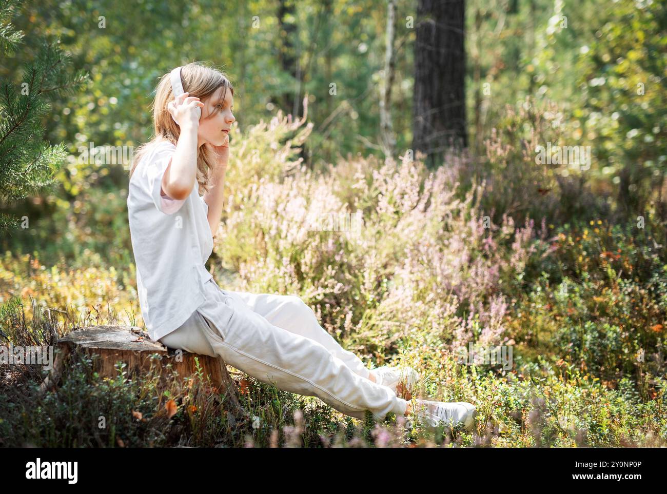 A teenage girl who breathes fresh air and relieves stress in the forest ...