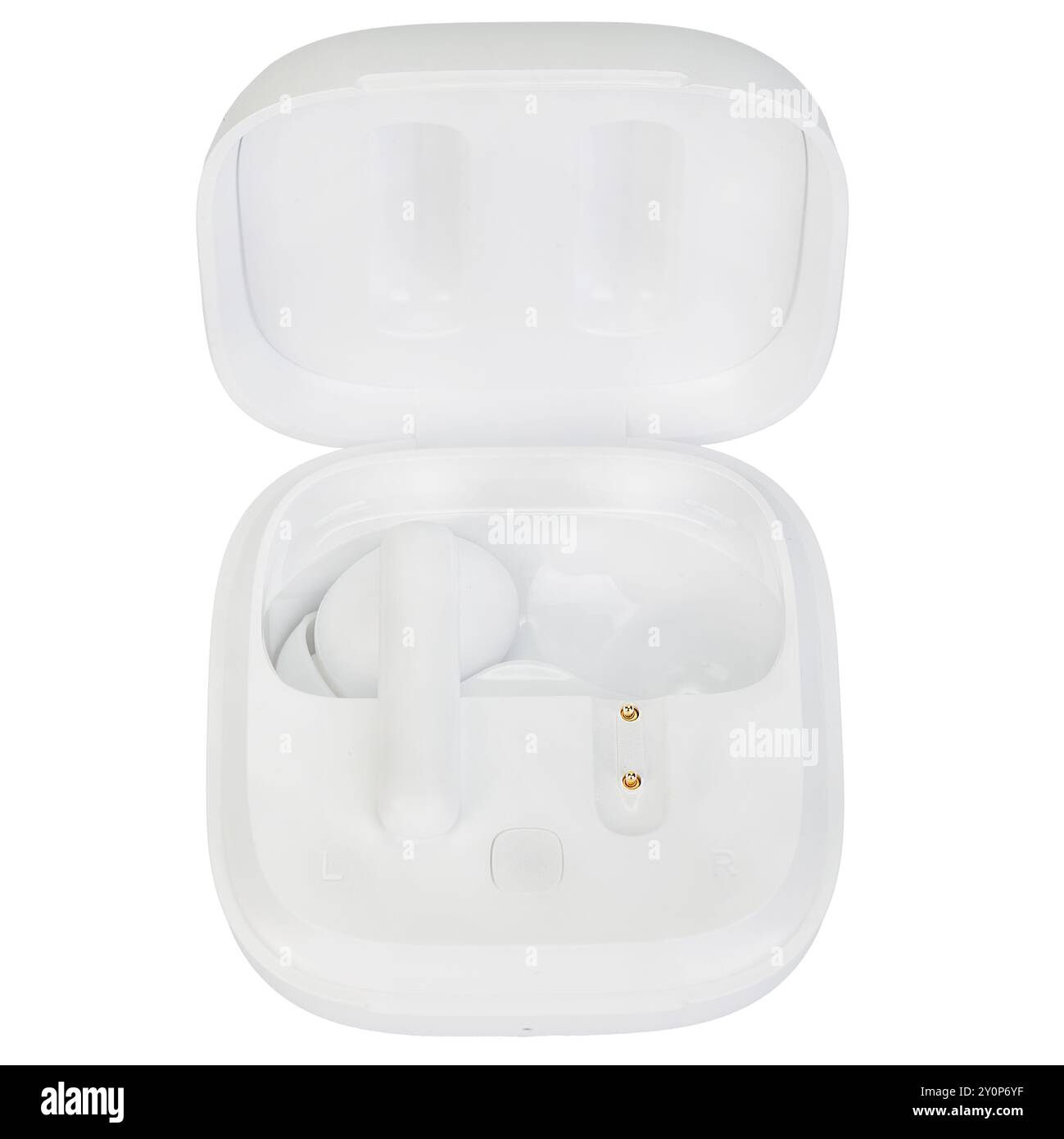 Top view of white wireless earbuds placed in an open charging case on a white background. Stock Photo