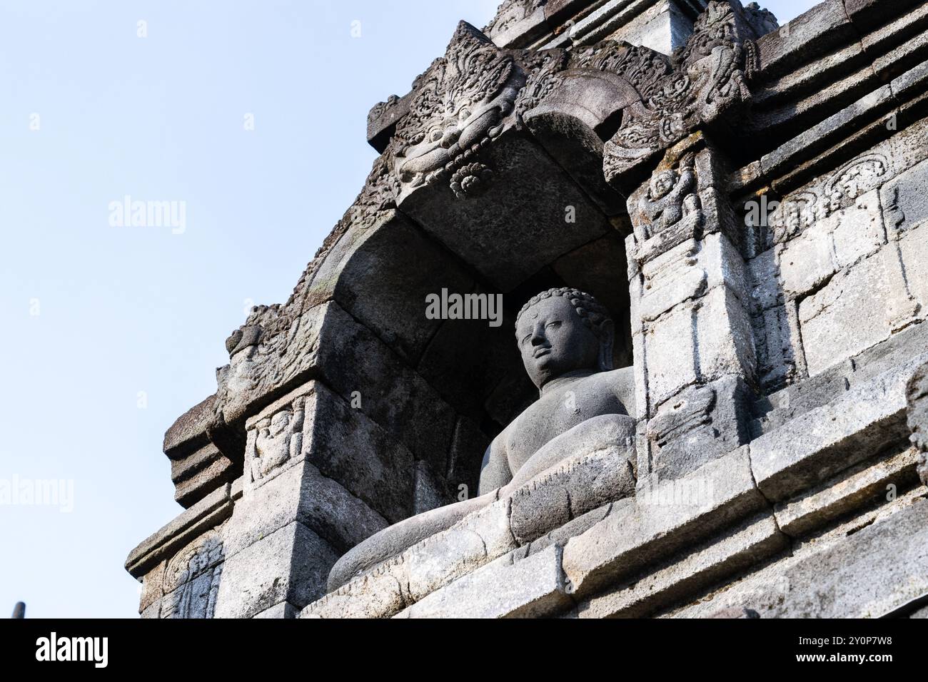Ancient buddha statue is sitting peacefully inside borobudur temple, a ...