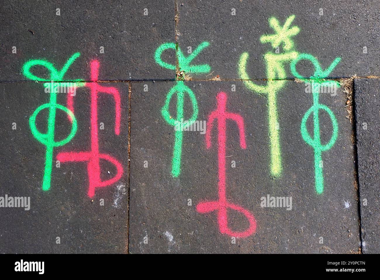 Coloured symbols spray painted onto the pavement in London to indicate the underground position of utilitiy infrastucture such as pipes and cables. Stock Photo