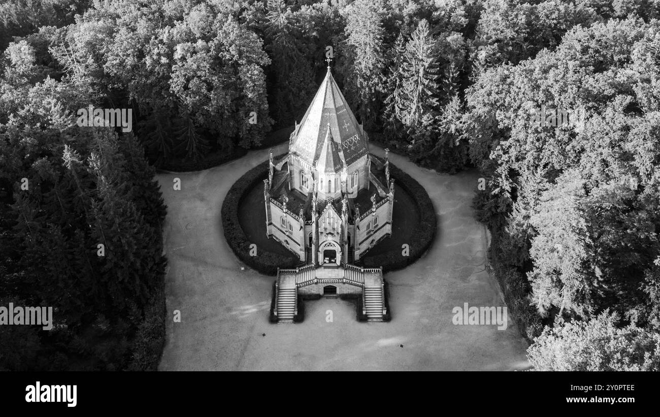 The Schwarzenberg Tomb stands majestically in Domanin near Trebon, surrounded by lush greenery. The intricate architecture is complemented by a serene garden. Black and white photography. Stock Photo