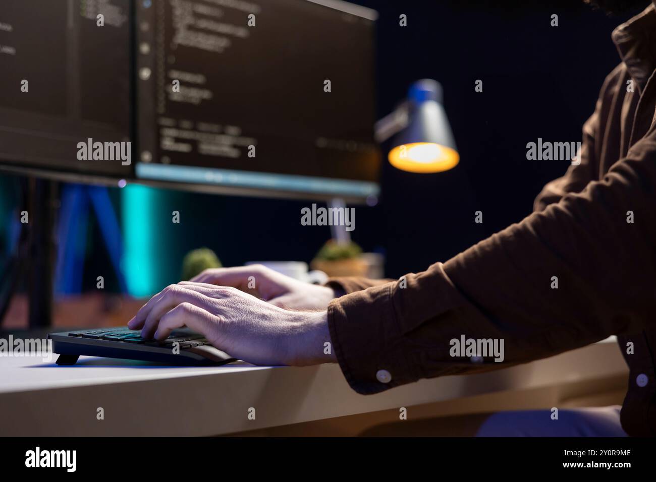 Computer scientist typing on keyboard, implementing security measures to protect company systems and data. IT specialist writing, testing and debugging Java code for software applications, close up Stock Photo