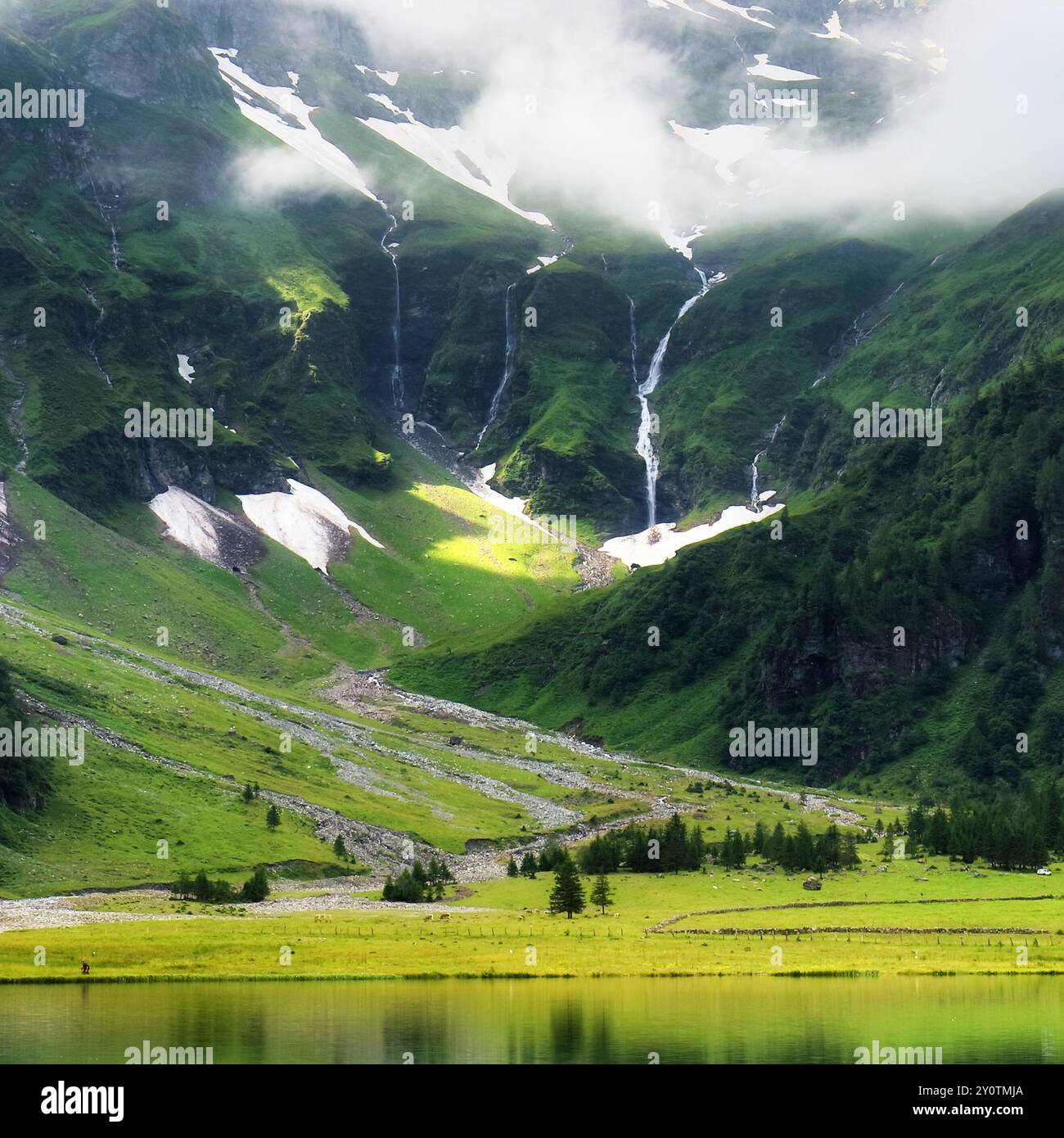 Beautiful summer lake landscape with mountain in the Autria Alps. Wonderful hiking spot. Alpine lake with high mountains. Pine trees. Hohe Tauern near Stock Photo
