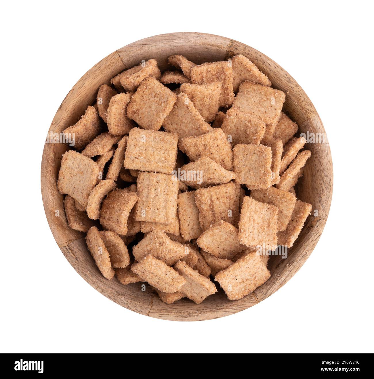 wooden bowl of crunchy granola, cinnamon toast crunch isolated on white background with clipping path, heap of flakes with cinnamon Stock Photo