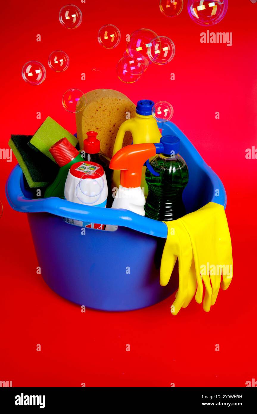 group of cleaning products on red dust background Stock Photo - Alamy