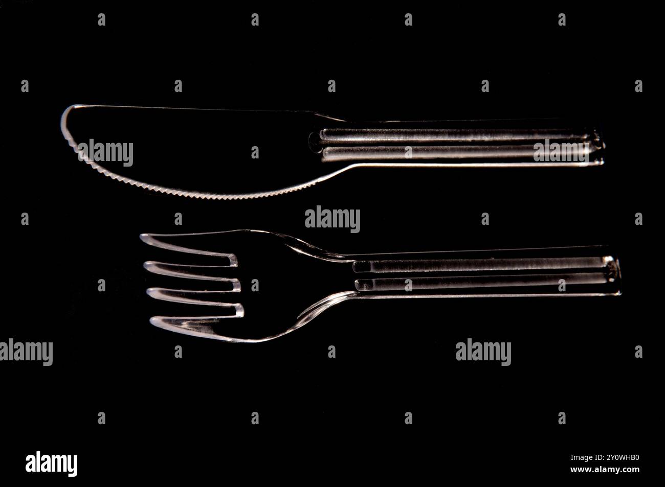 plastic fork and knife on black background Stock Photo