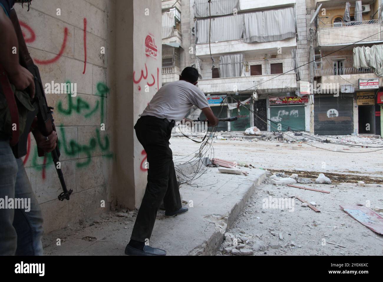 Syrian rebel firing on the Assad army during heaving fighting Stock ...