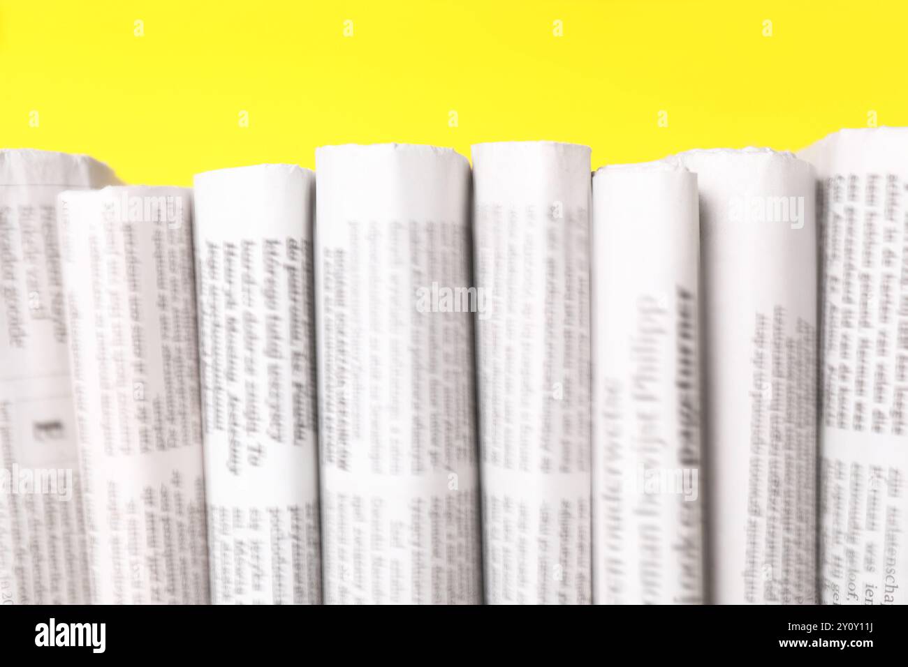 Random Newspaper Yellow Many newspapers in different languages on yellow background, closeup ...