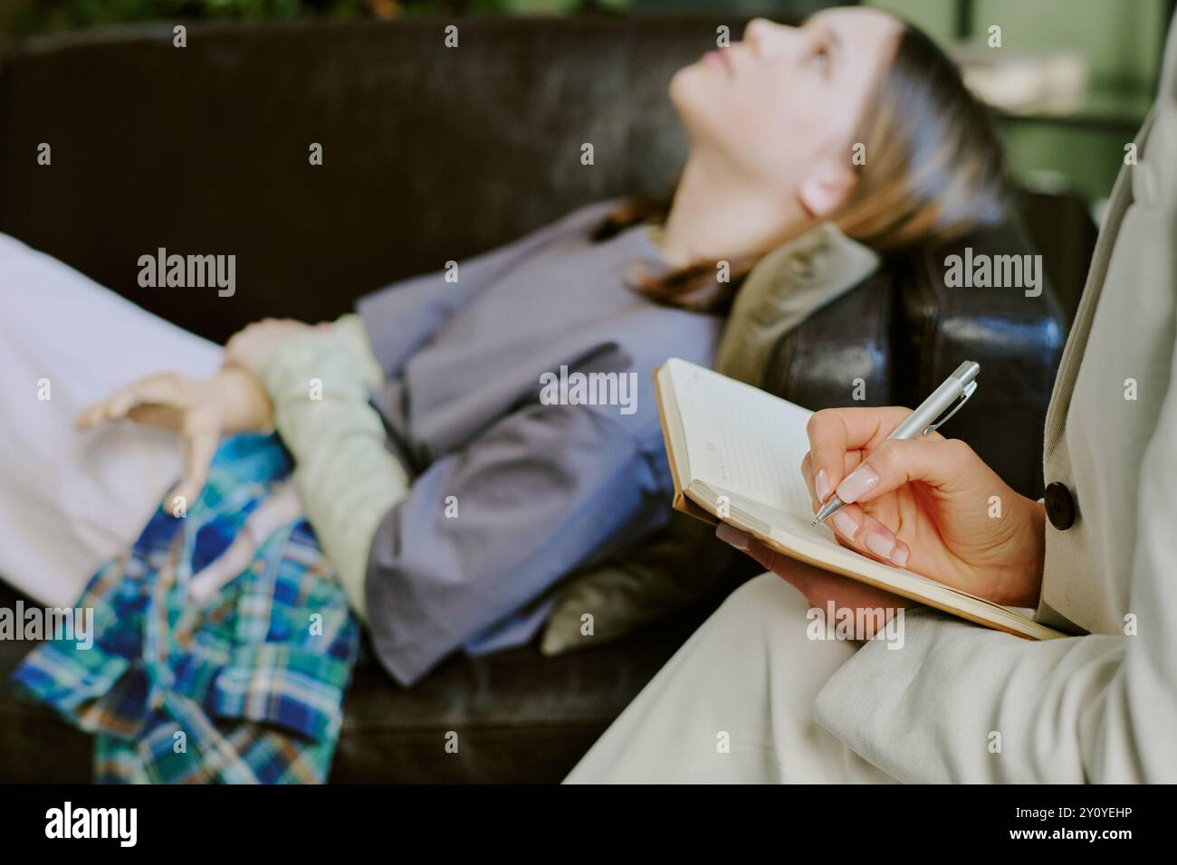Attentively Listening While Taking Notes During Therapy Session Stock Photo