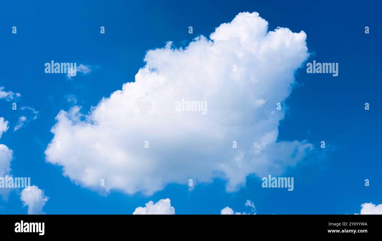 A fluffy white cloud floating in a clear blue sky, capturing the simplicity and beauty of nature. Perfect for illustrating themes of tranquility, free Stock Photo